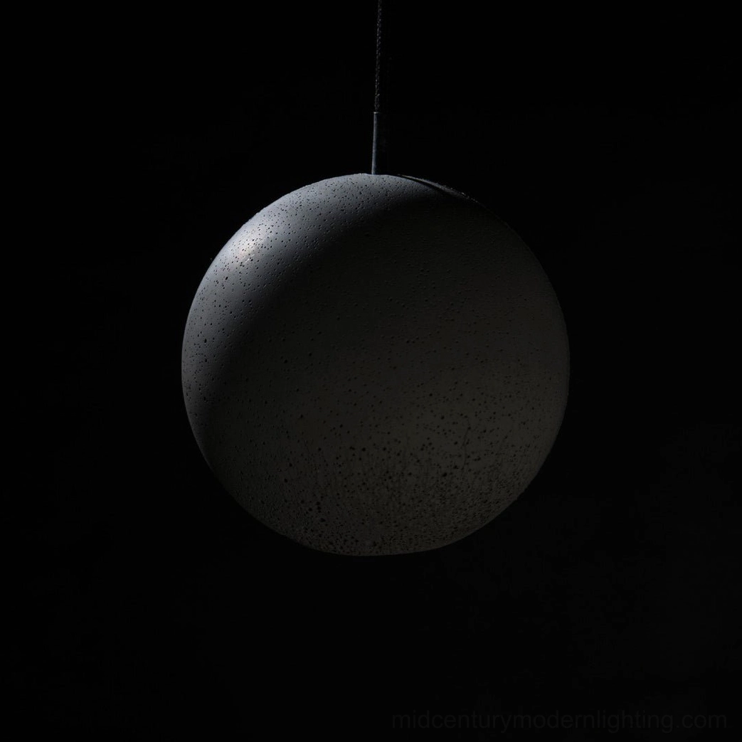 Concrete pendant lamp hanging installation showing suspension cord and fixture height proportion