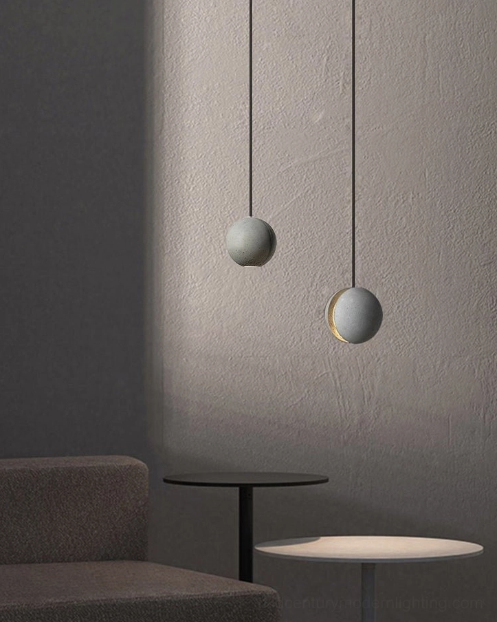 Concrete pendant lamp showing hemispheric form and light emission characteristics in studio setting