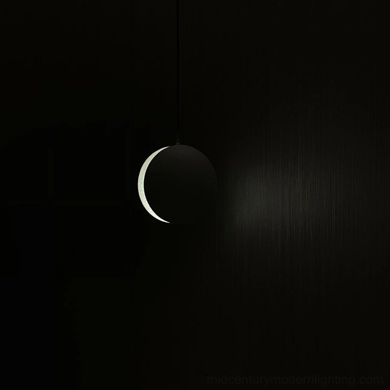 Concrete pendant lamp with hemisphere design demonstrating light diffusion through matte surface