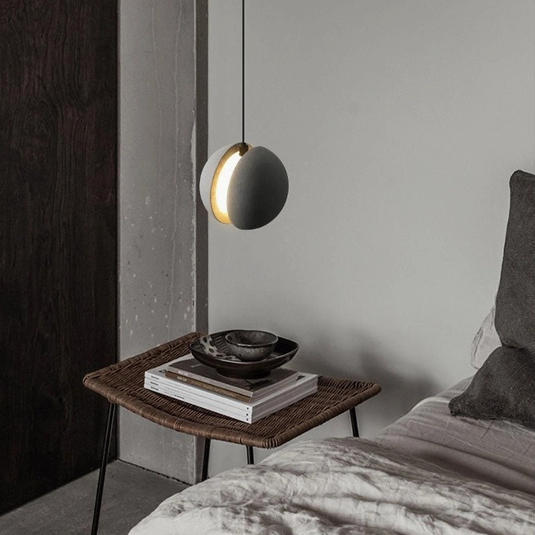 Concrete pendant lamp installation in contemporary minimalist space showing ambient lighting effect