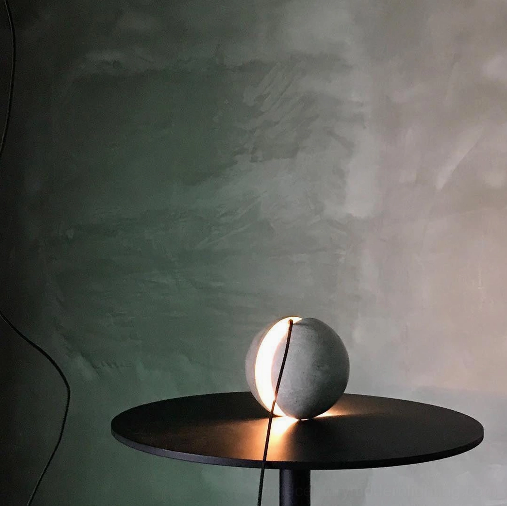 Concrete pendant lamp with split design creating visual interest through light and shadow interplay