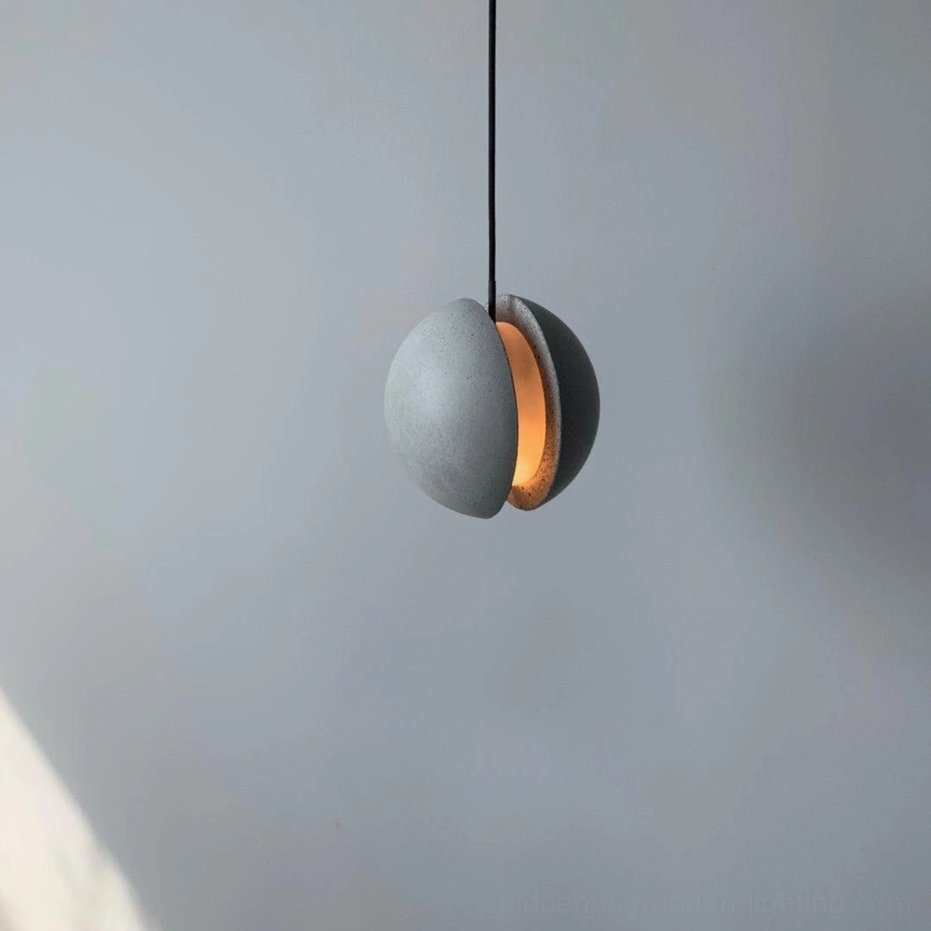 Concrete pendant lamp suspended in interior space demonstrating installation height and visual proportion