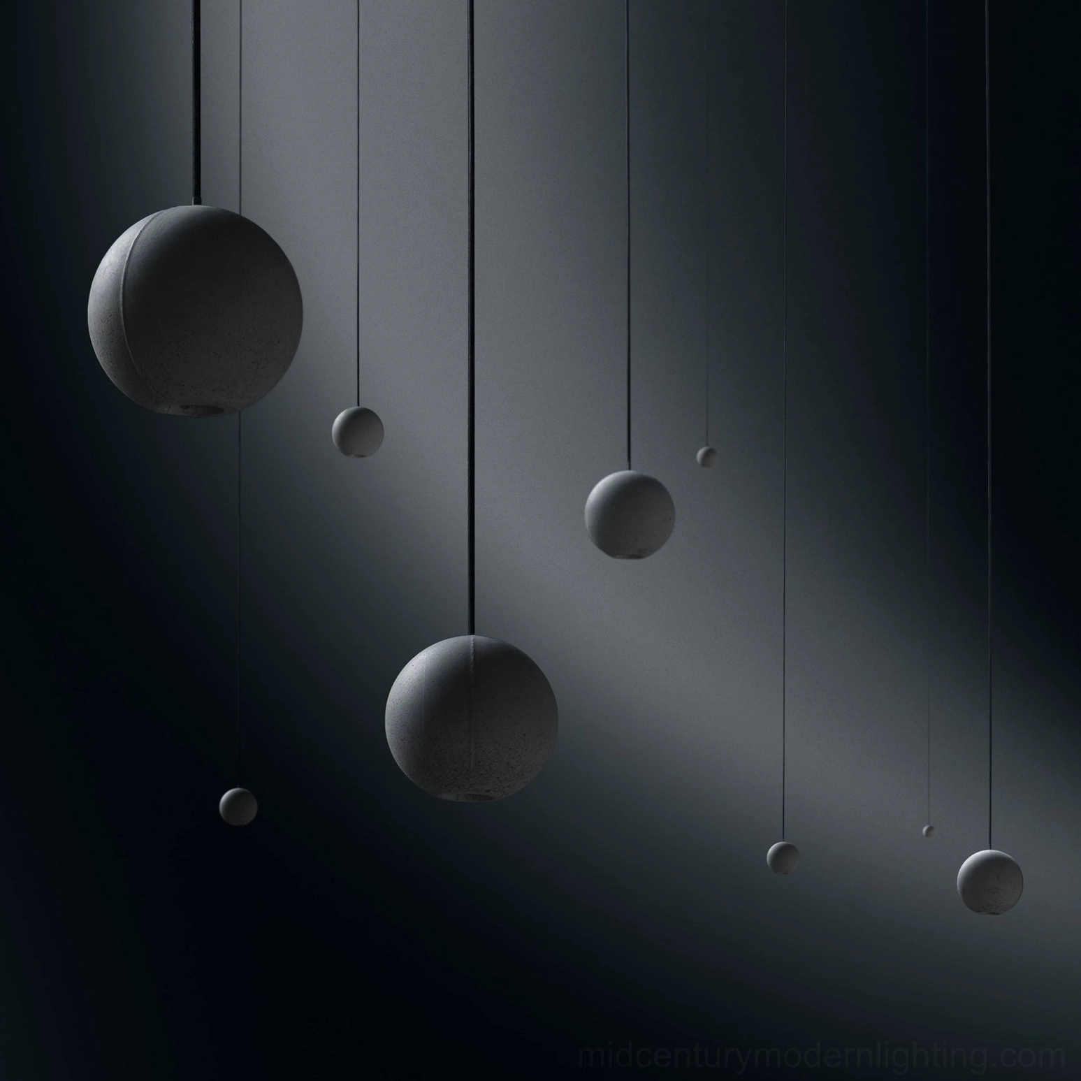 Artistic arrangement of concrete pendant lamps showing sculptural qualities and design variety
