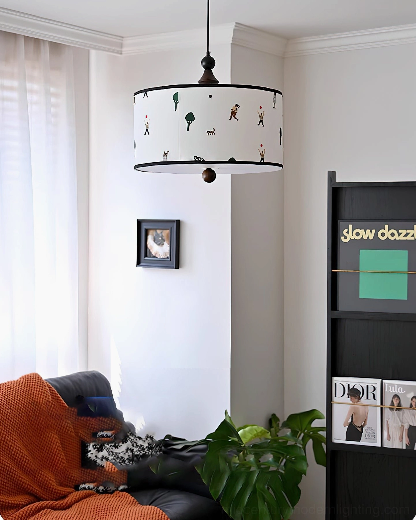 Cozy casual modern living room with Congo drum pendant light suspended above seating area, high-angle side view
