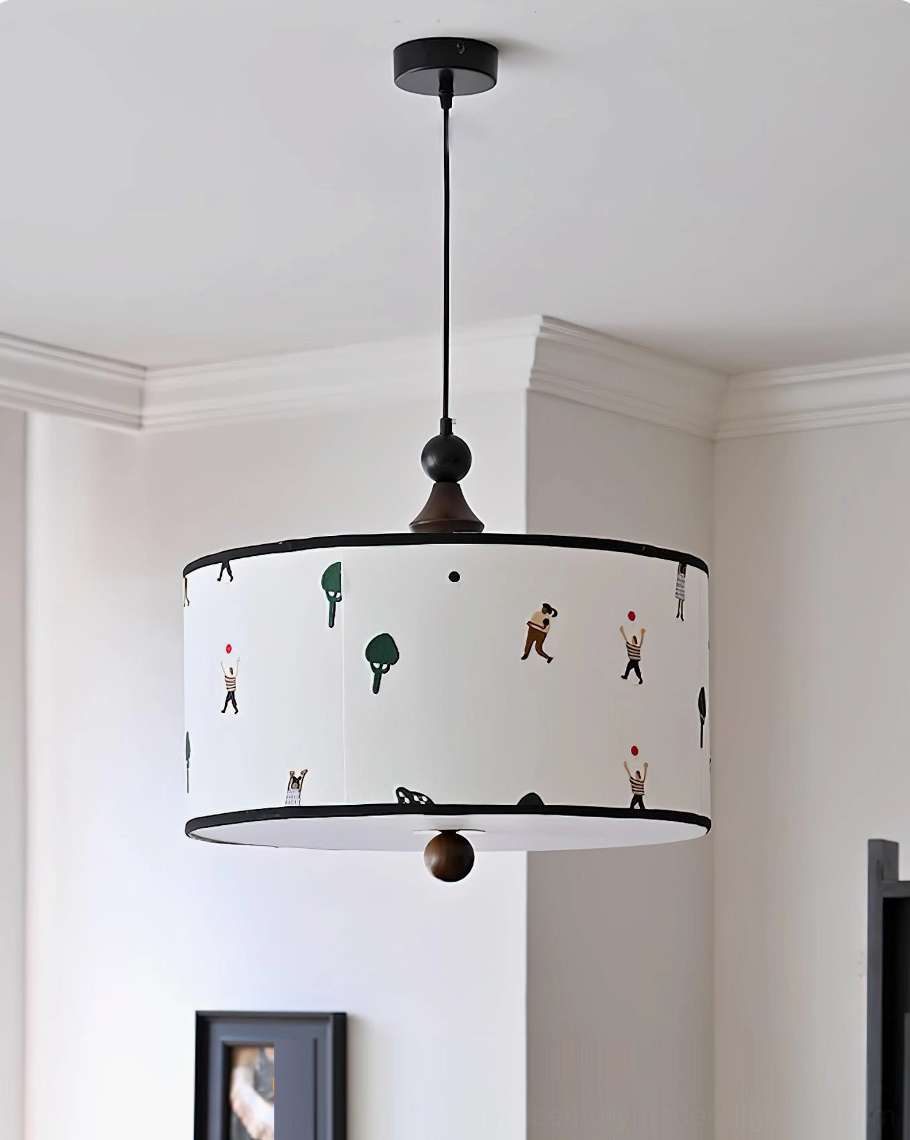 Congo pendant light with whimsical illustrations displayed in minimalist living space with wall art, direct front view