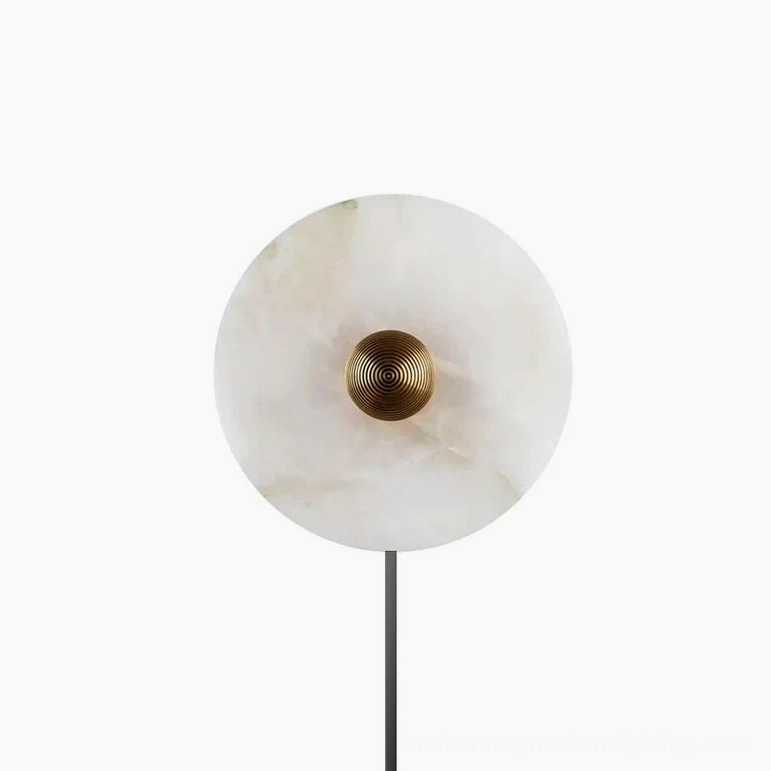 Contemporary round alabaster plug-in sconce showcasing minimalist form and soft luminous glow