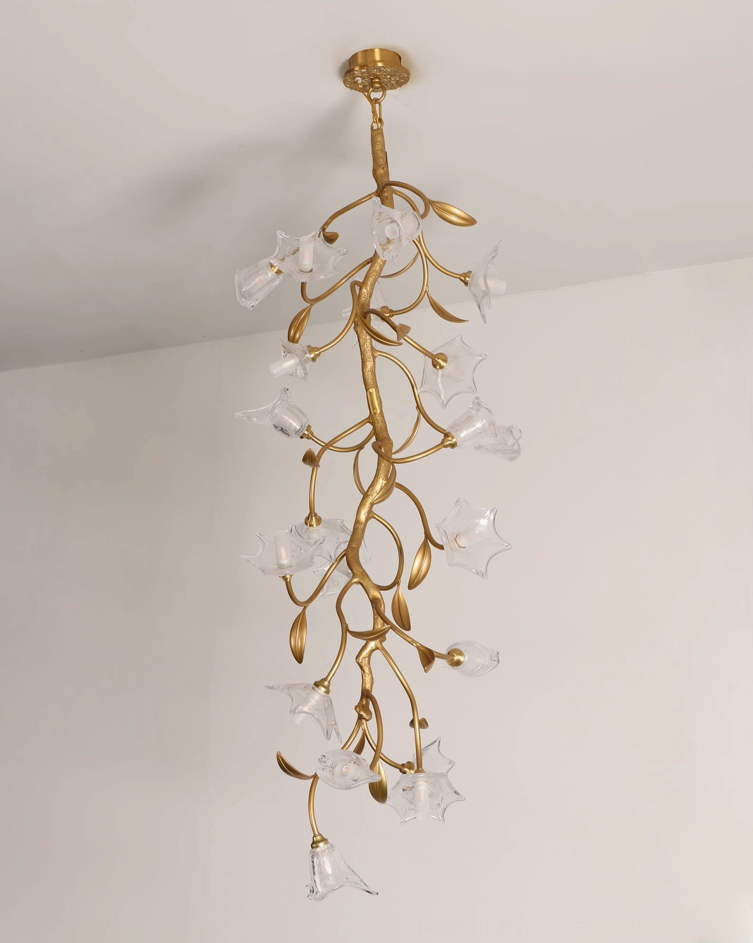 Contemporary botanical branch chandelier creating warm ambient light in modern living space
