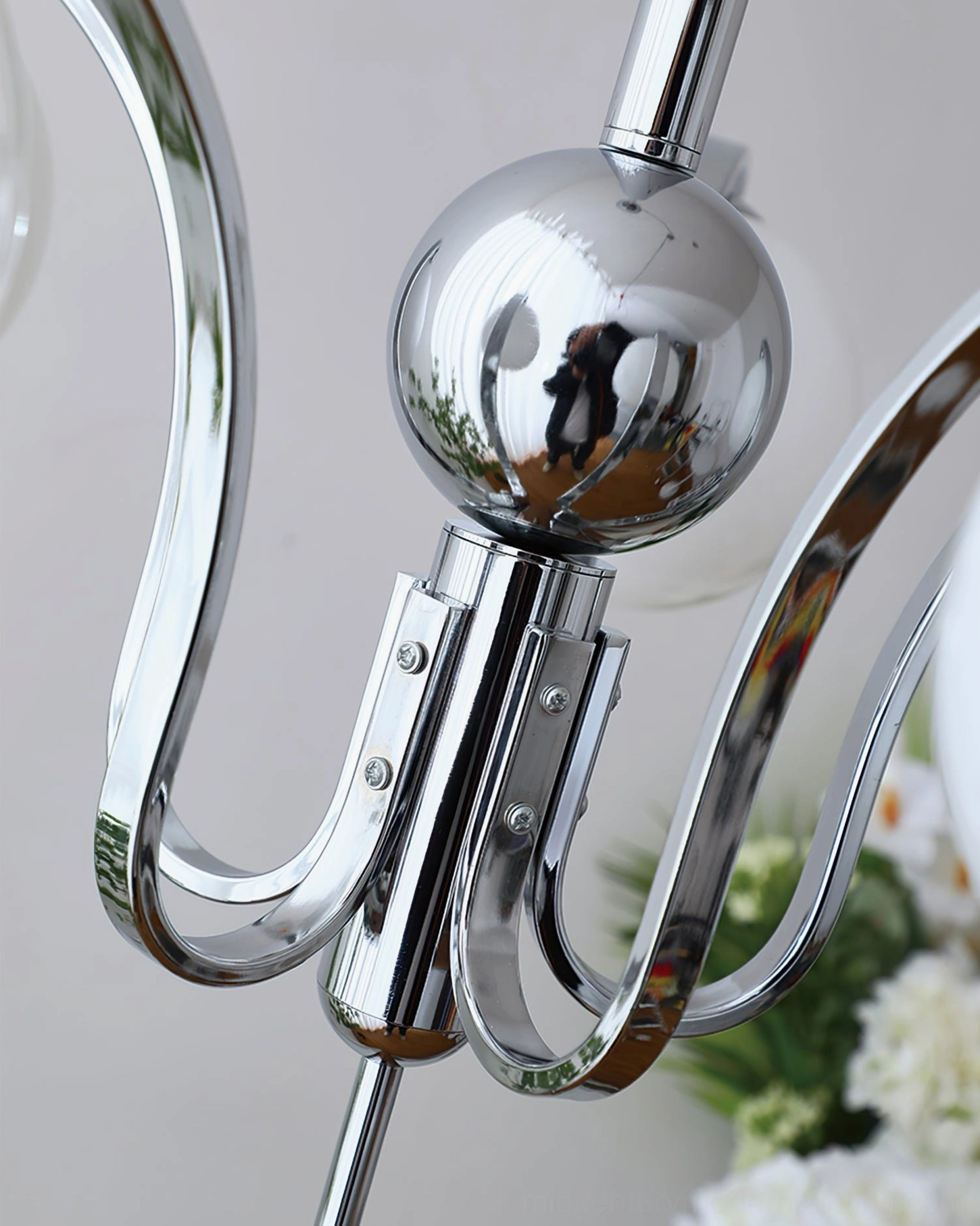 Contemporary glass globe chandelier with beige shades and curved chrome arms architectural detail