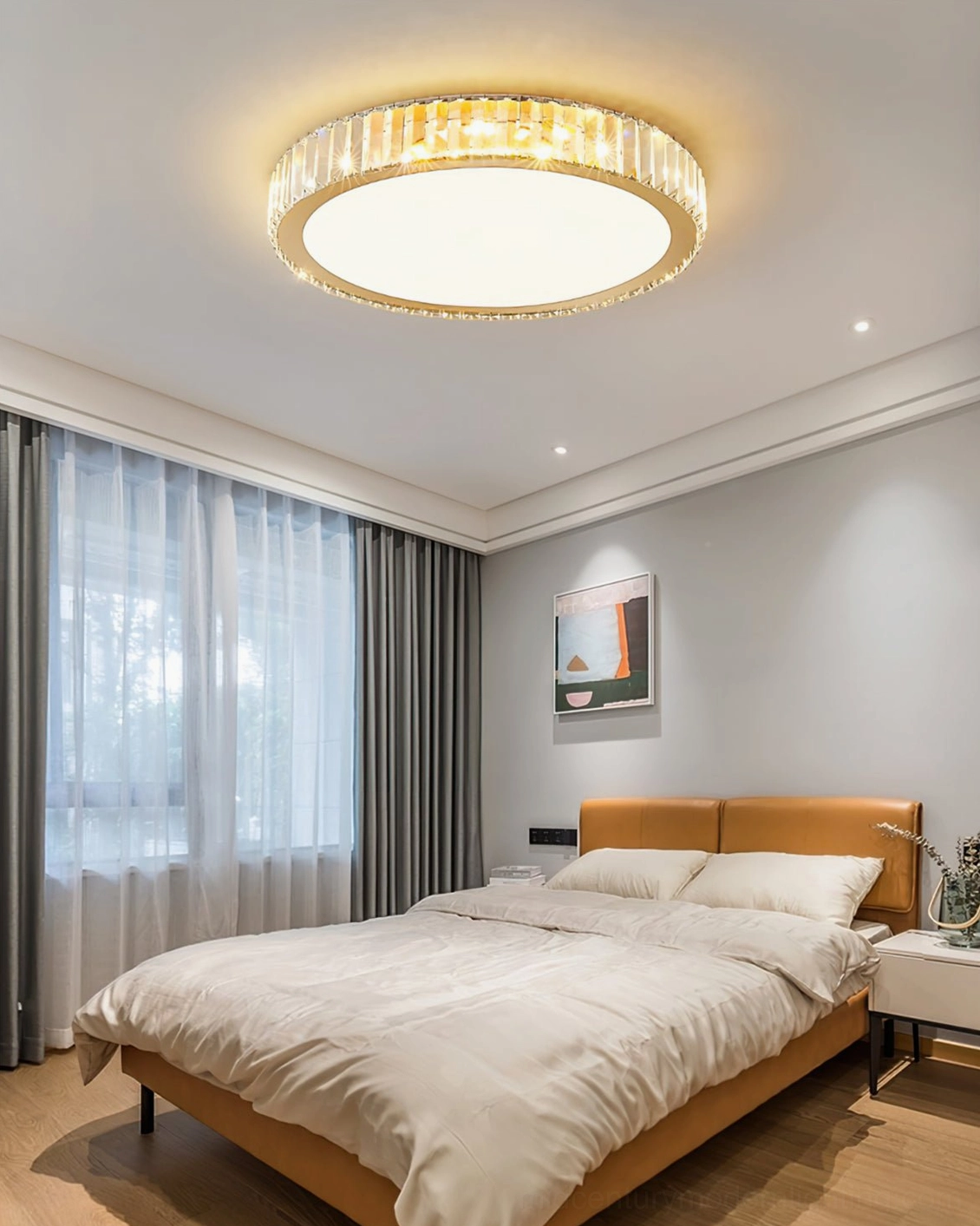 Contemporary round crystal ceiling lamp creating warm glow in calm modern bedroom