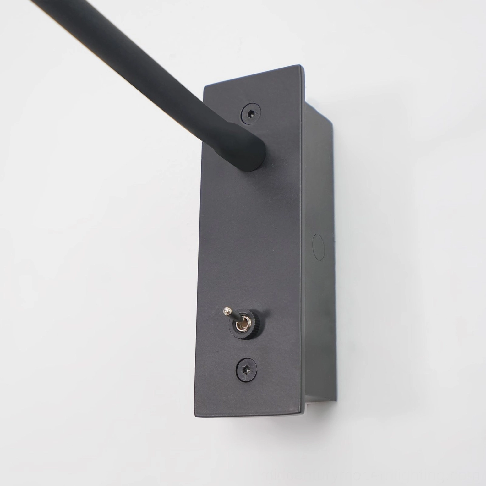Contemporary gooseneck LED wall sconce bedroom installation, warm light reading setup