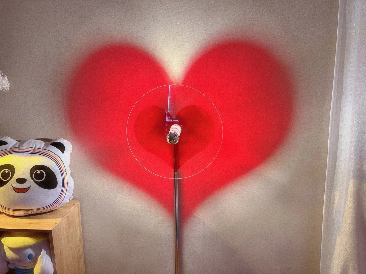 Heart-shaped projection floor lamp highlighting minimalist contemporary interior design aesthetic