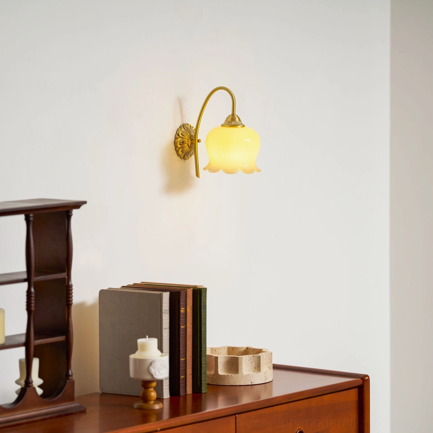 Mid-century lily of the valley brass wall lamp mounted in contemporary styled interior space