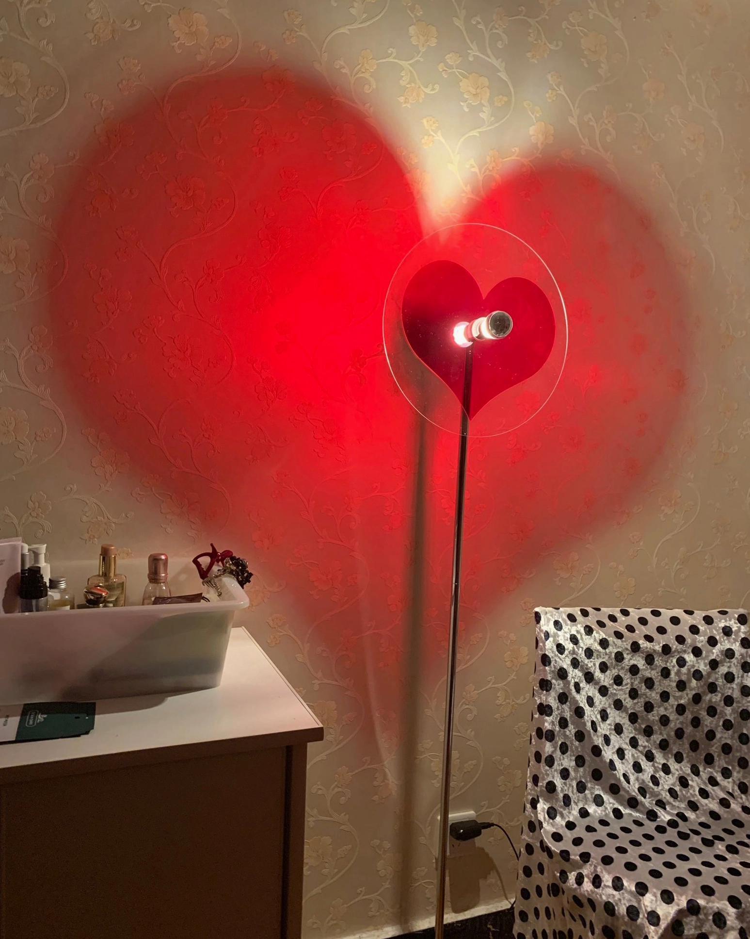Contemporary red heart projection floor lamp enhancing home ambiance with artistic light effect