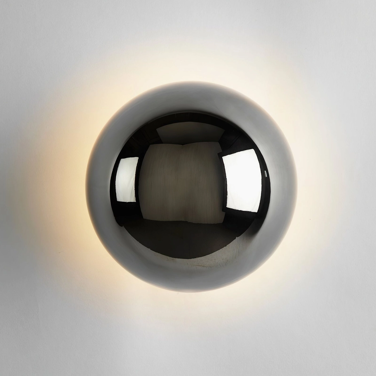 Contemporary minimalist sphere wall lamp in polished chrome metal construction