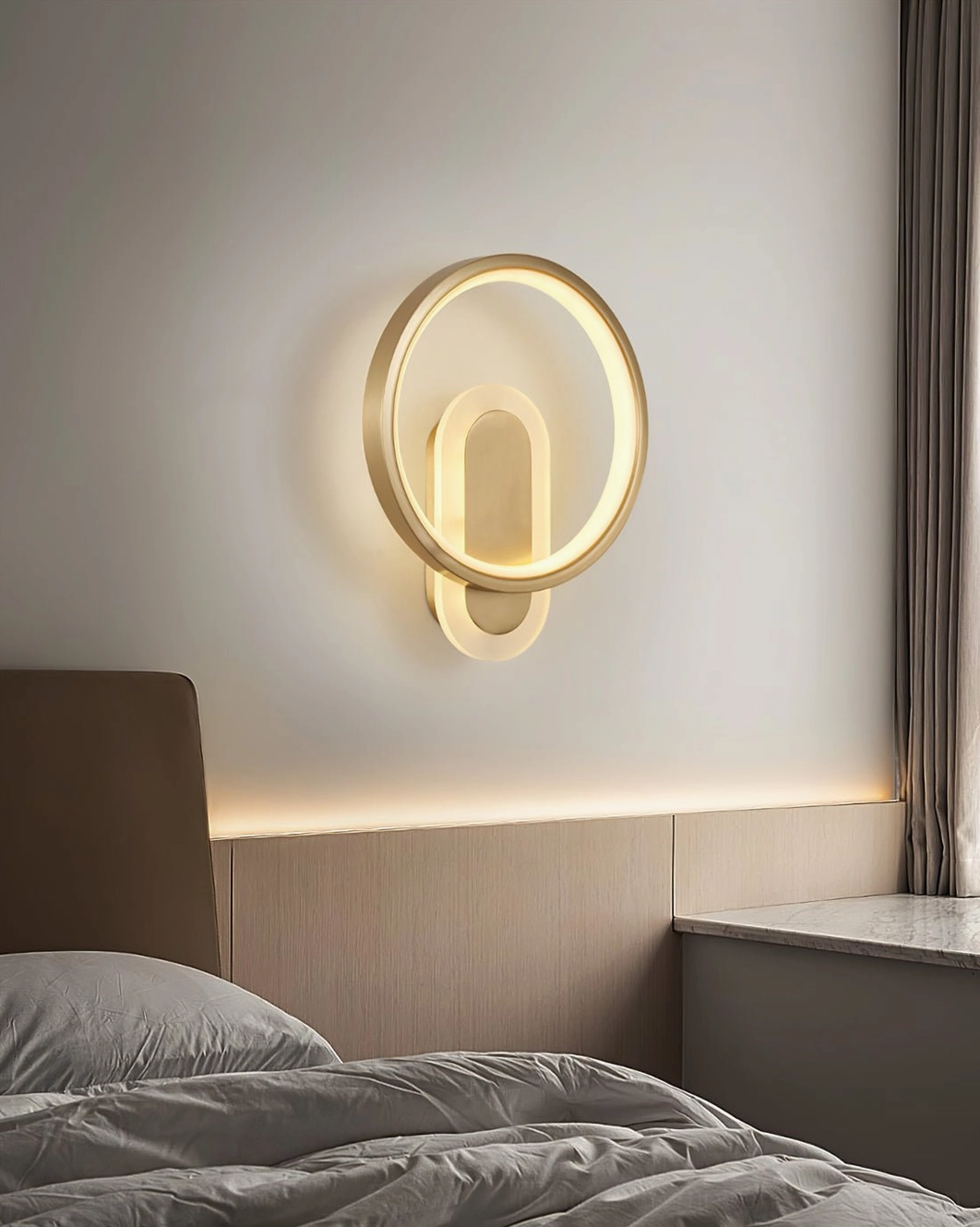 Minimalist gold ring wall lamp installed beside dark wood bedroom headboard contemporary style