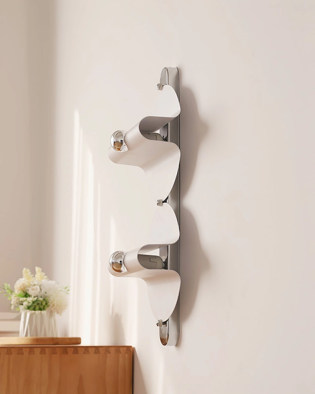 Single modern wall sconce unlit showing matte white finish and streamlined chrome head
