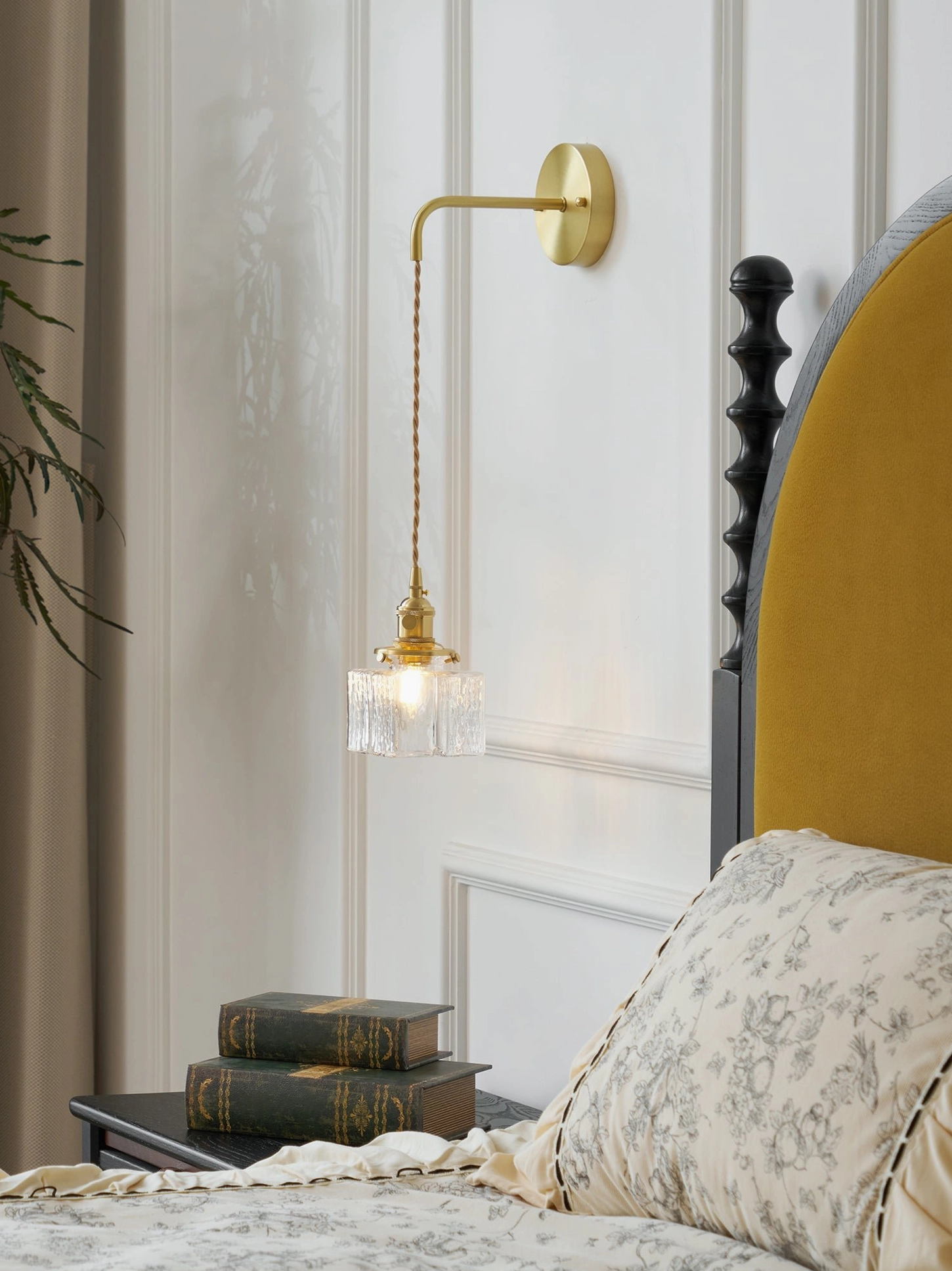 Cozy vintage brass pendant wall lamp with square textured glass in bedroom with books display