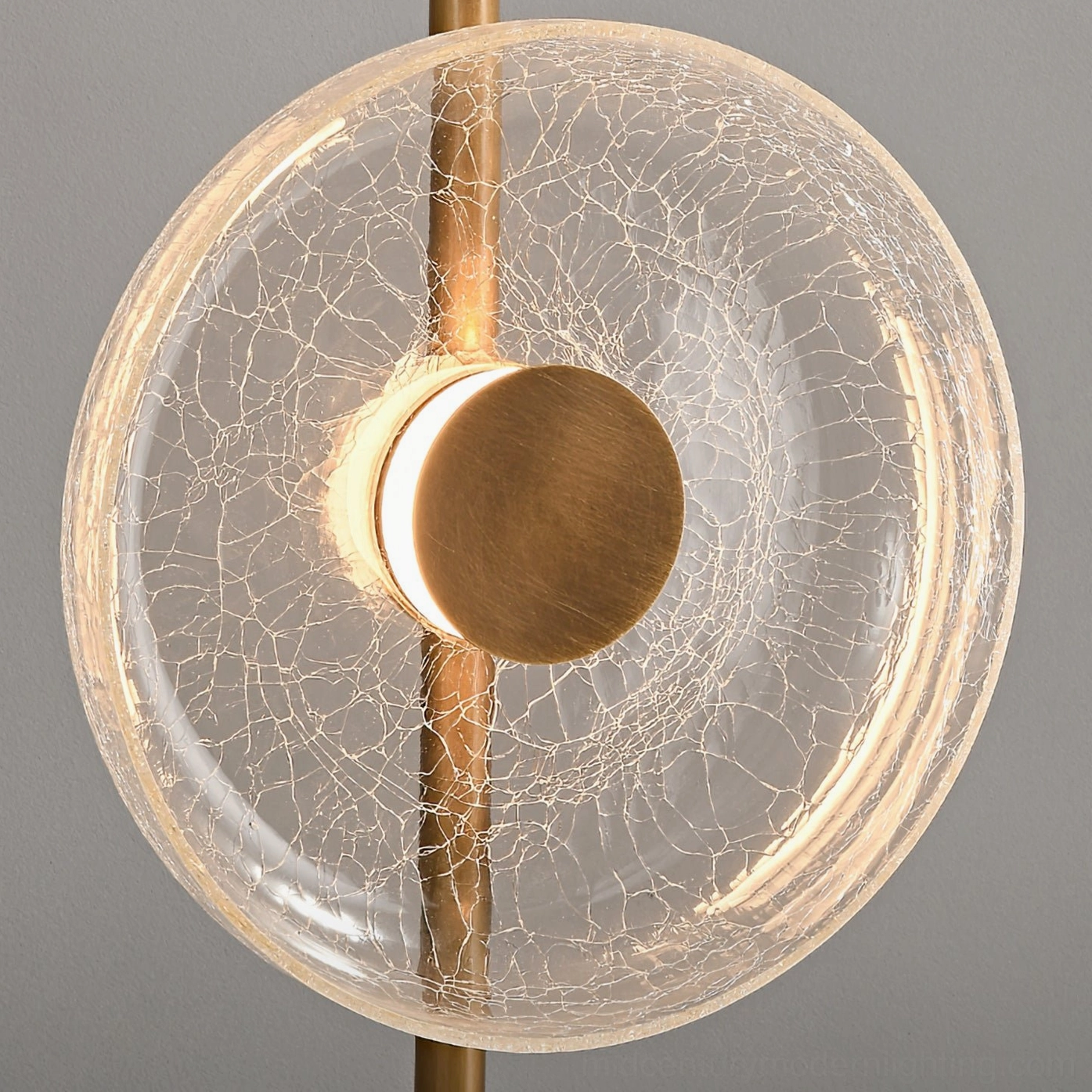 Crackle glass lampshade close-up showing fractured clear glass texture with brass central fixture detail