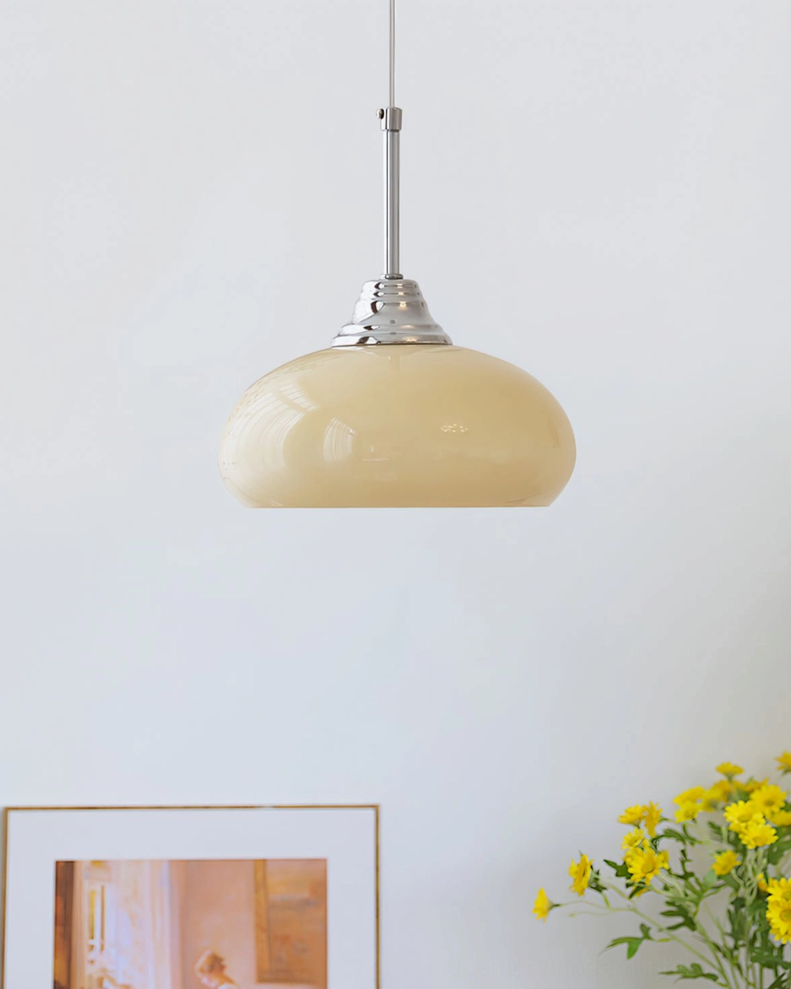 Cream Bell Pendant Light illuminating home corner with yellow flowers and botanical artwork