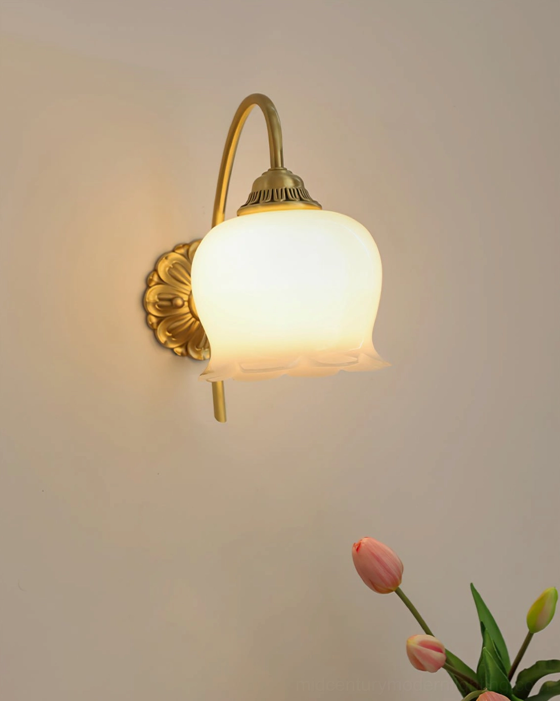 Mid-century modern wall lamp with illuminated frosted glass cover and smooth tulip flower decor below
