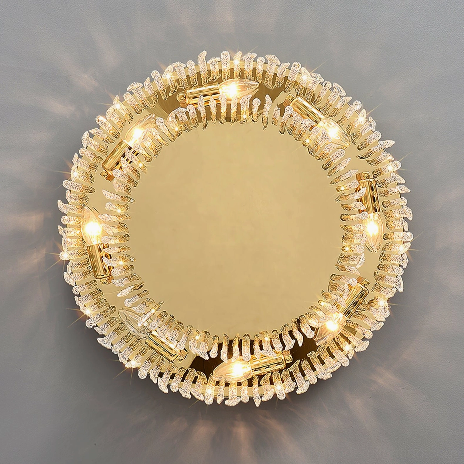 Overhead close-up of crystal flush mount showing faceted crystal accents and E14 bulb sockets with gold hardware