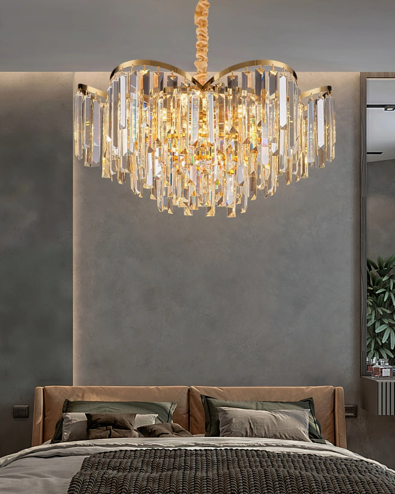 Crystal chandelier installed in modern master bedroom with sparkling clear crystal decor and gold trim