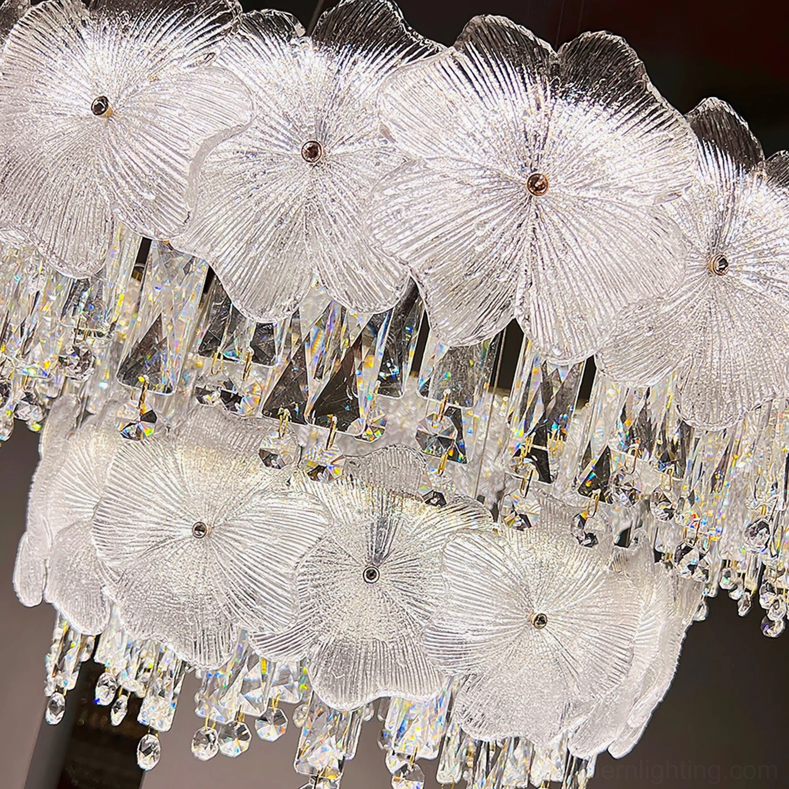 Chandelier crystal detail macro close-up showing faceted clear crystals and precision-cut floral glass base optical refraction