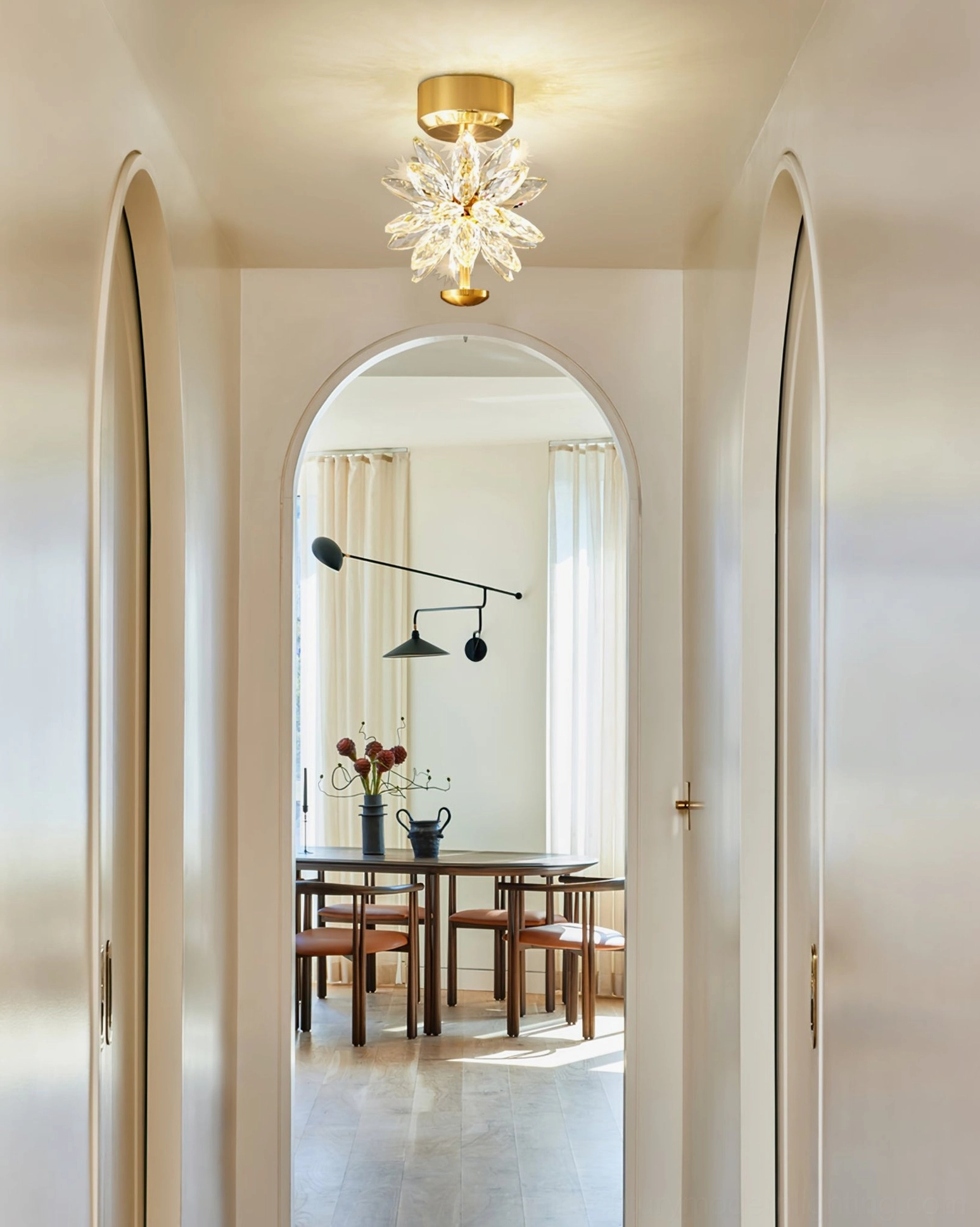 Crystal flower ceiling fixture in interior space showing scale and proportion with warm ambient lighting