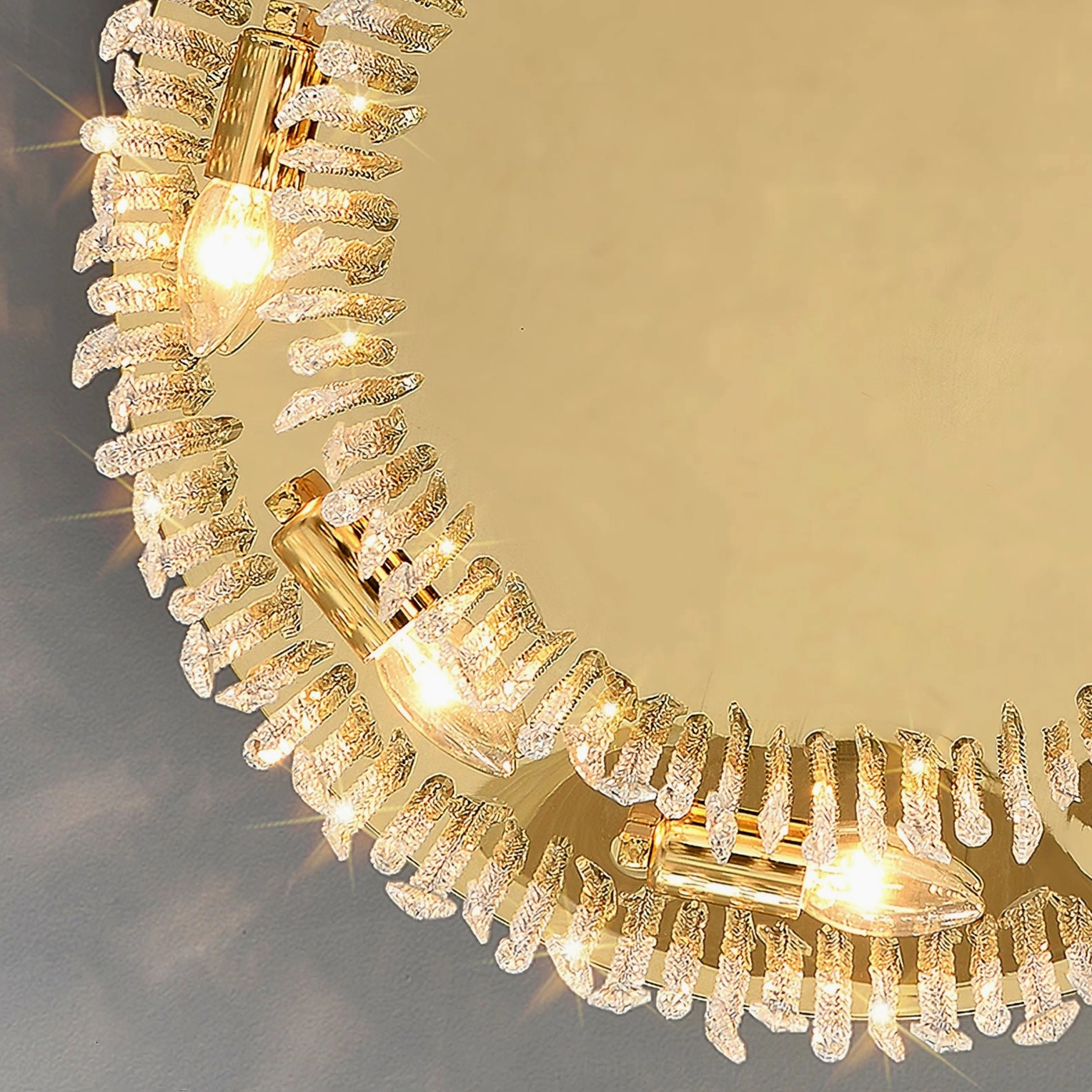 Interior close-up detail of crystal ceiling lamp showing layered crystal fringe, metal chains, and warm-lit E14 sockets