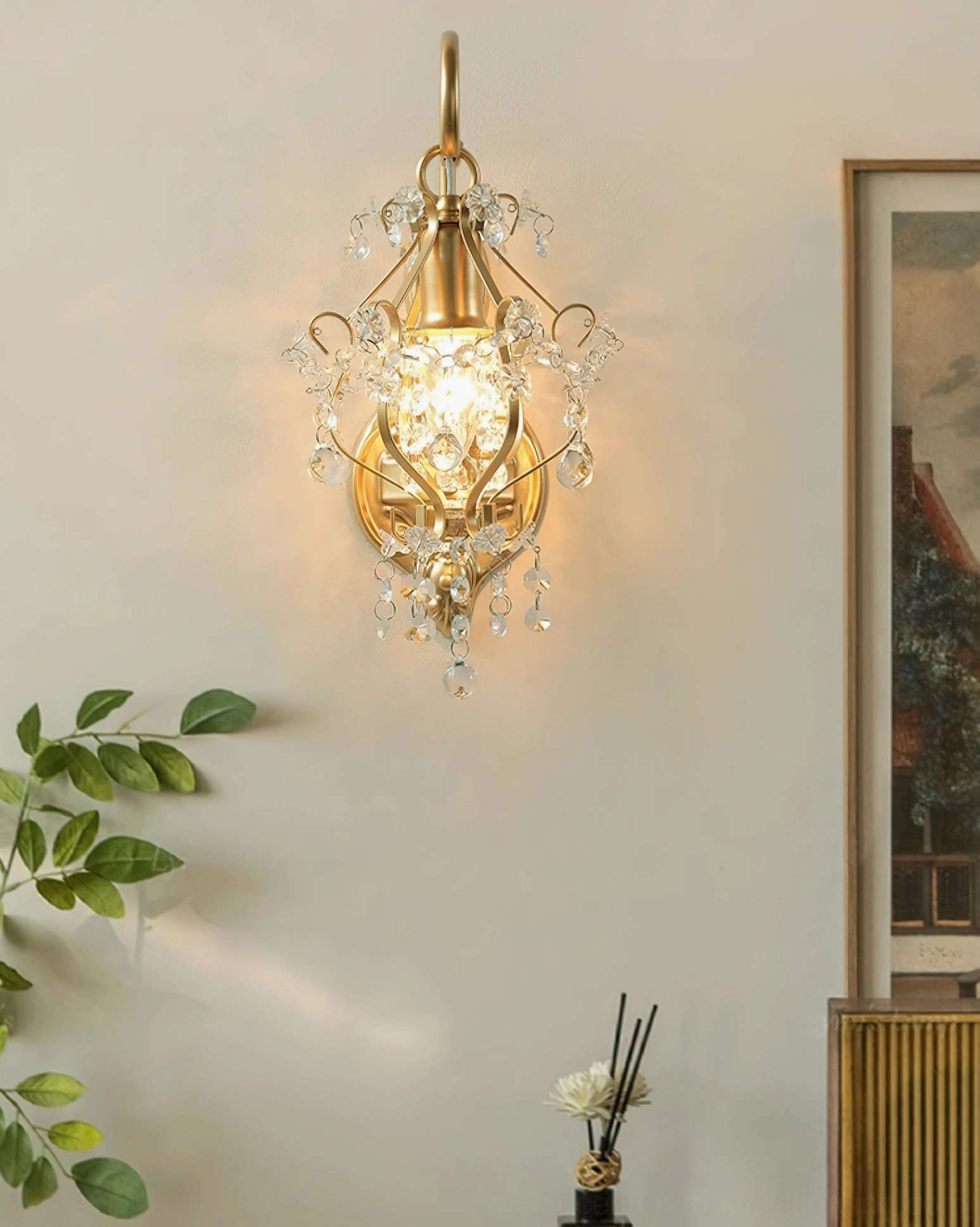 Wall-mounted crystal lamp in hallway interior with warm glowing illumination, wall art and green plant decoration