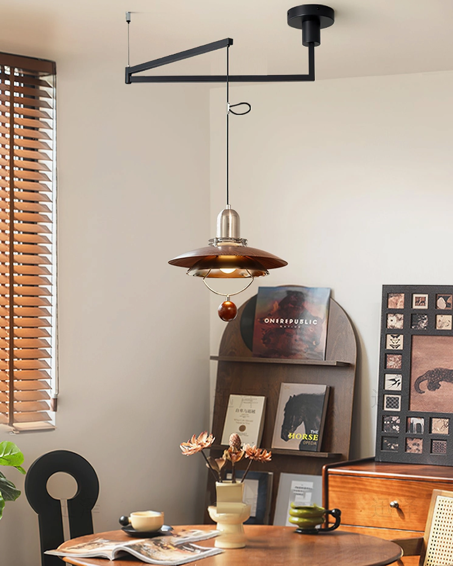 Vintage swing arm pendant light with walnut wood grain shade hanging in dining room - high angle view showing wooden bead detail