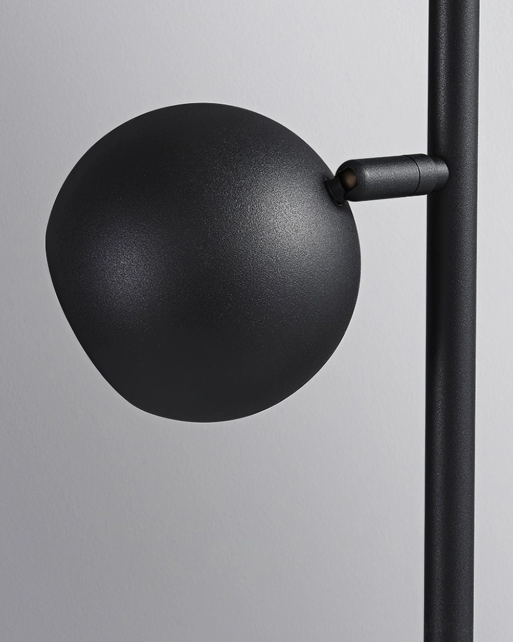 Dakota three-head floor lamp in studio lighting showcasing matte black finish and reflective gold accents