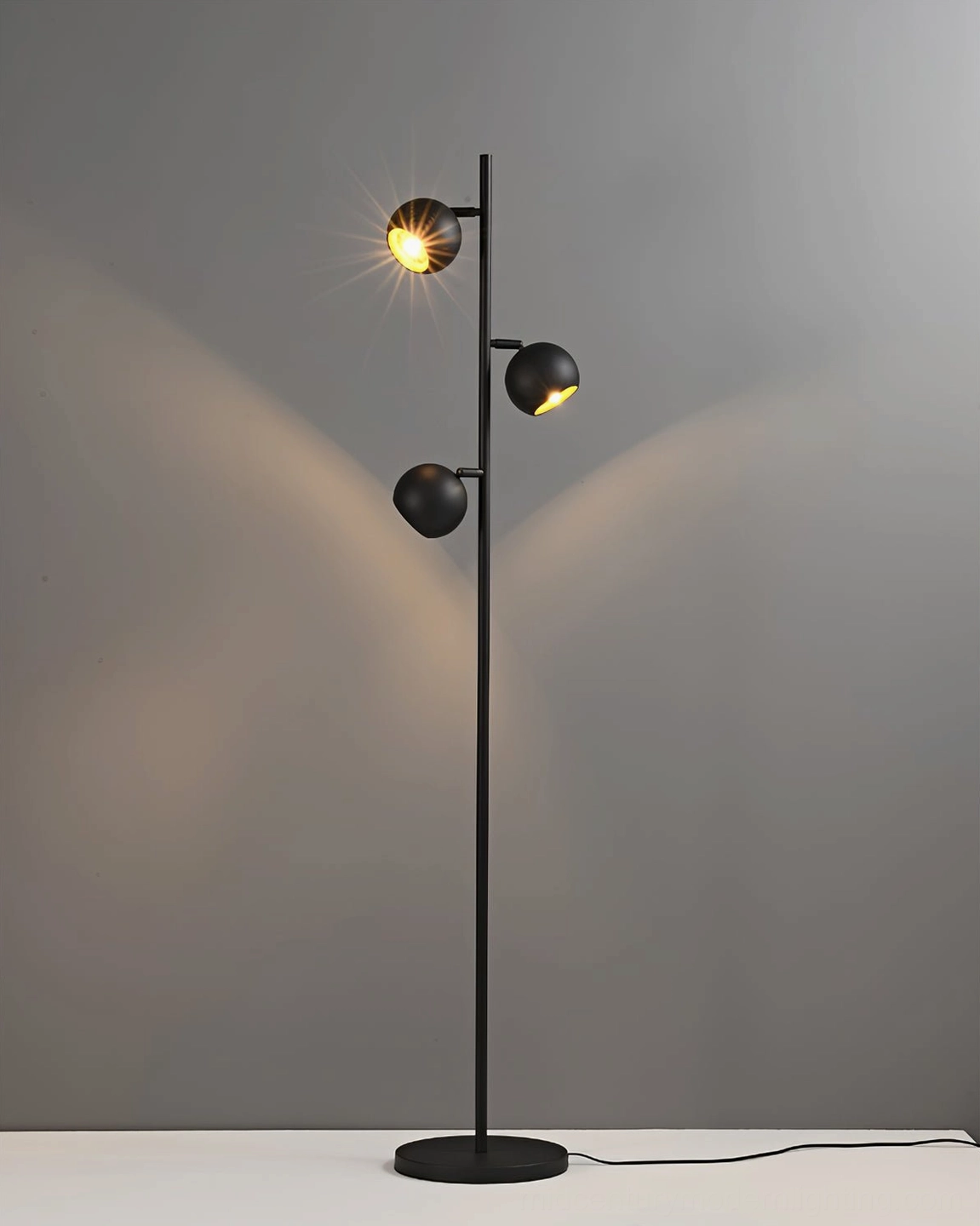 Dakota three-head floor lamp with warm glowing LED light emission, matte black metal construction