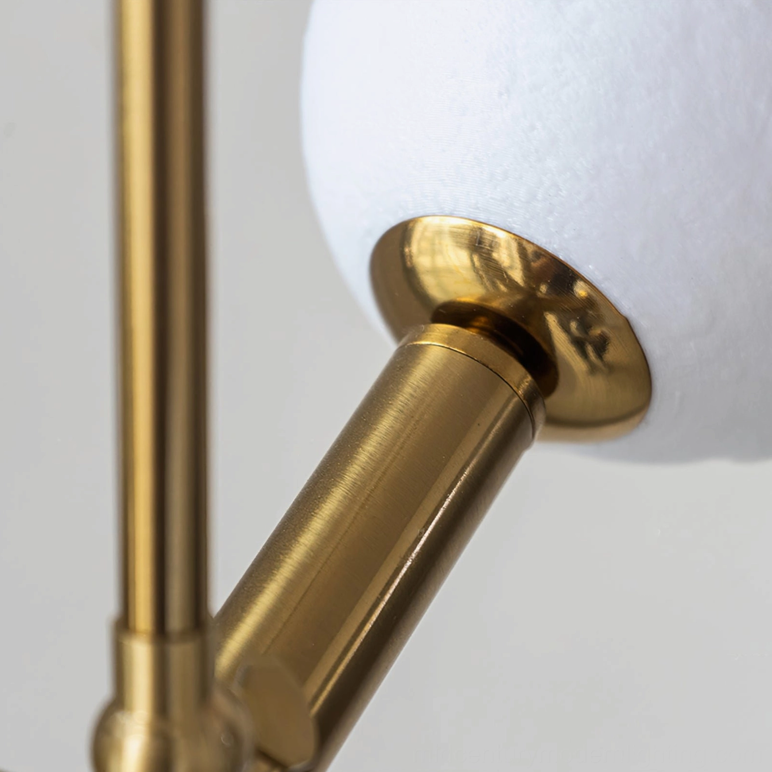 Textured moon glass shade detail on Dallas Planet Sputnik chandelier with polished brass hardware