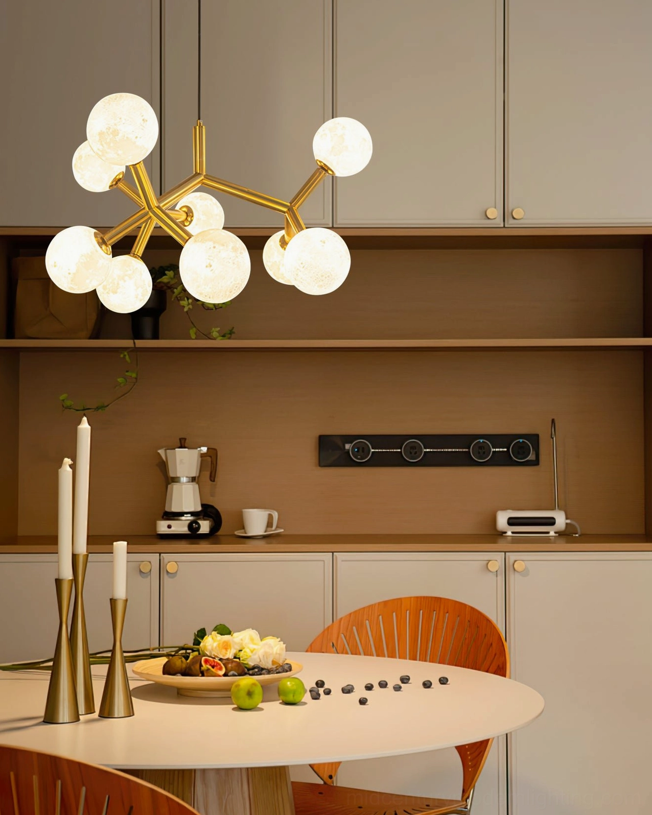 Dallas Planet mid-century modern Sputnik chandelier illuminated above dining area in minimalist contemporary kitchen