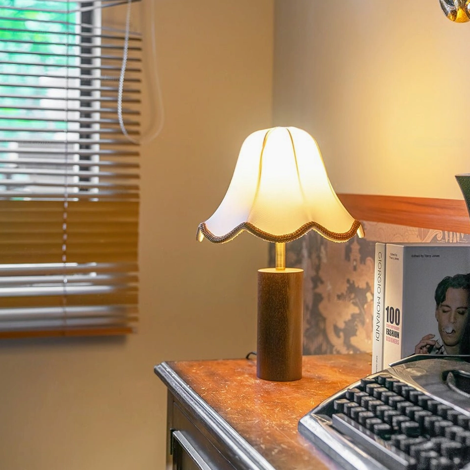 Illuminated Danika table lamp beside vintage wooden desk with typewriter and books, warm ambient lighting