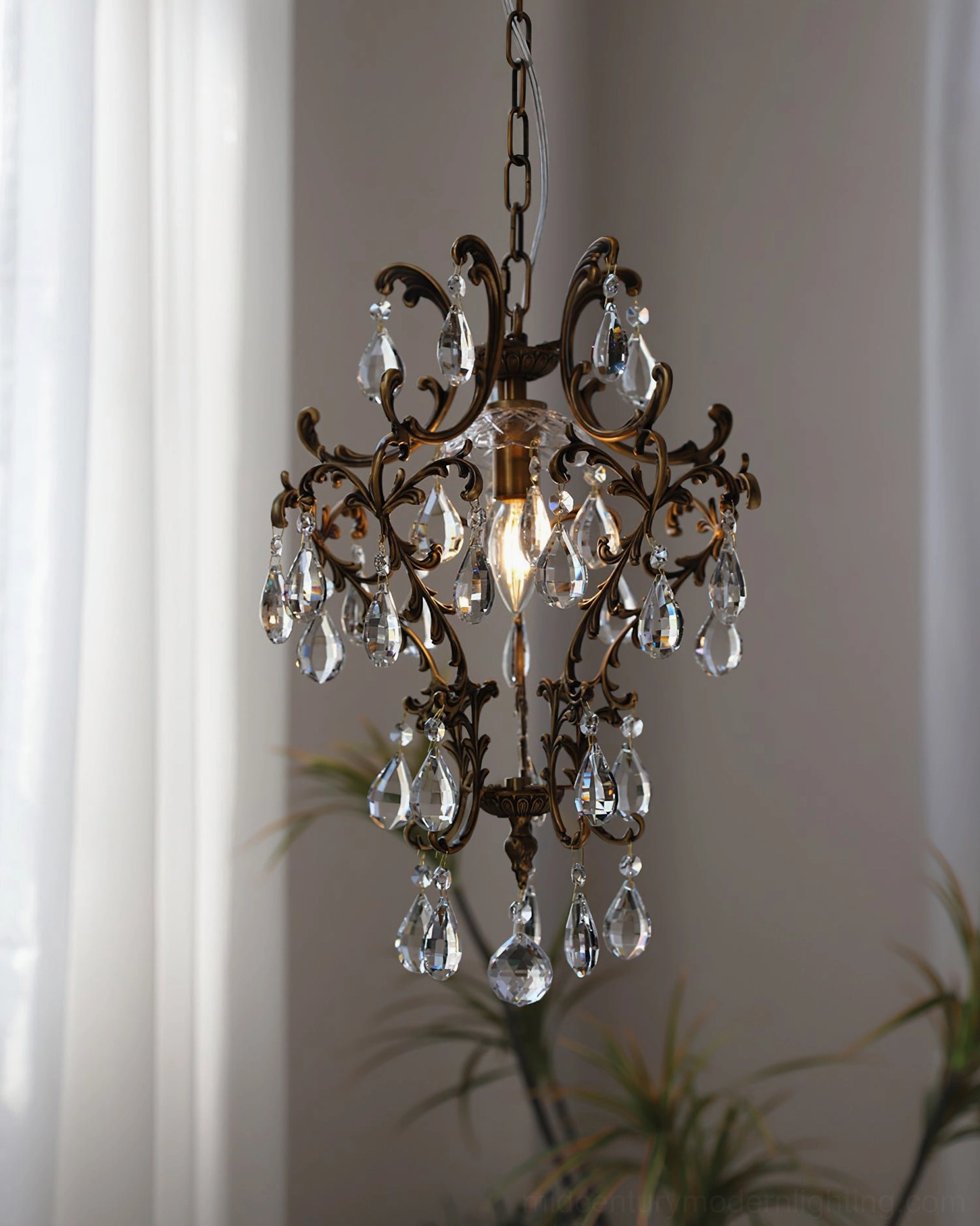 Dark bronze antique birdcage pendant with intricate scrollwork and crystal pendants, frontal overhead lighting design view