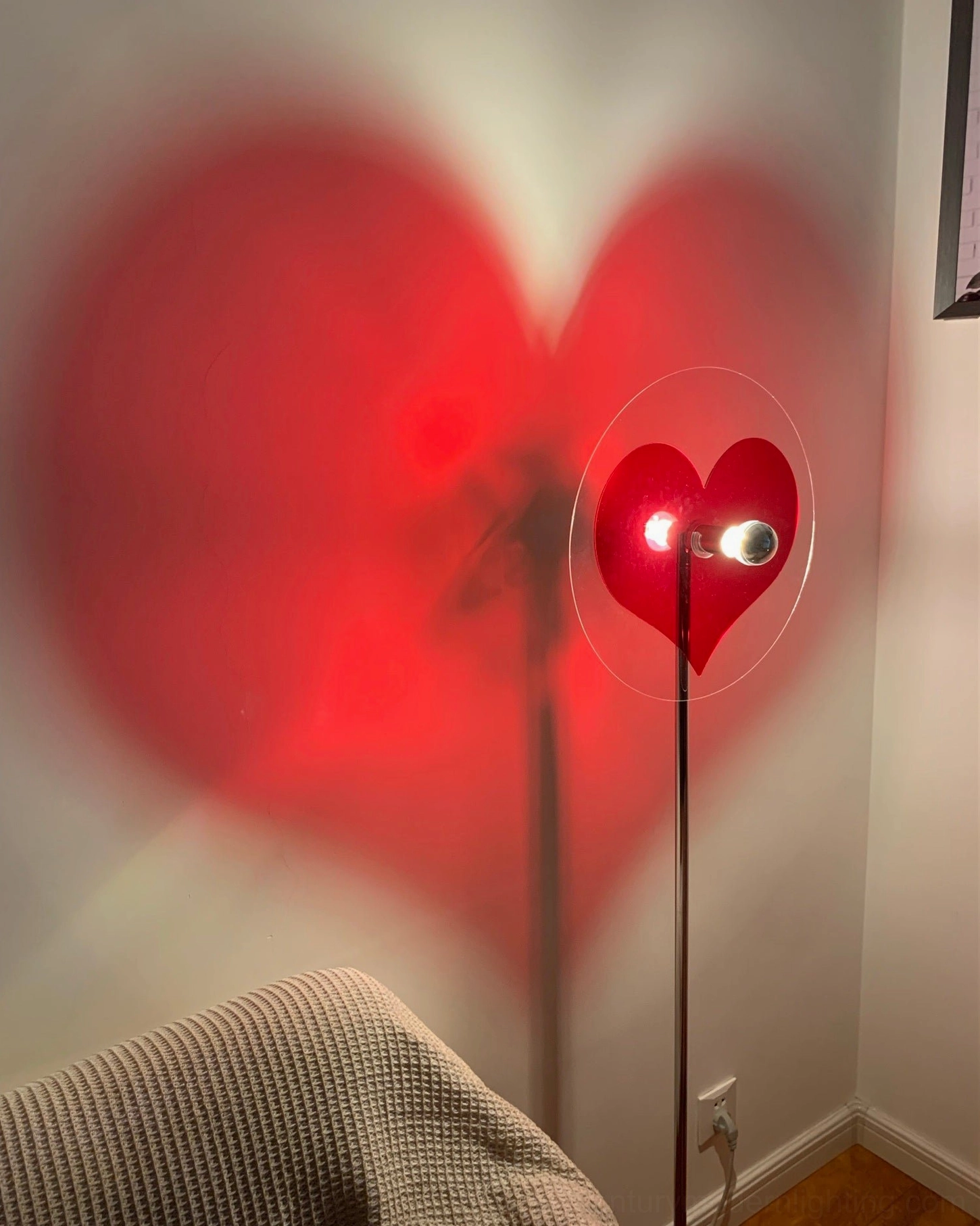 Modern heart projection floor lamp creating decorative atmospheric lighting in home space