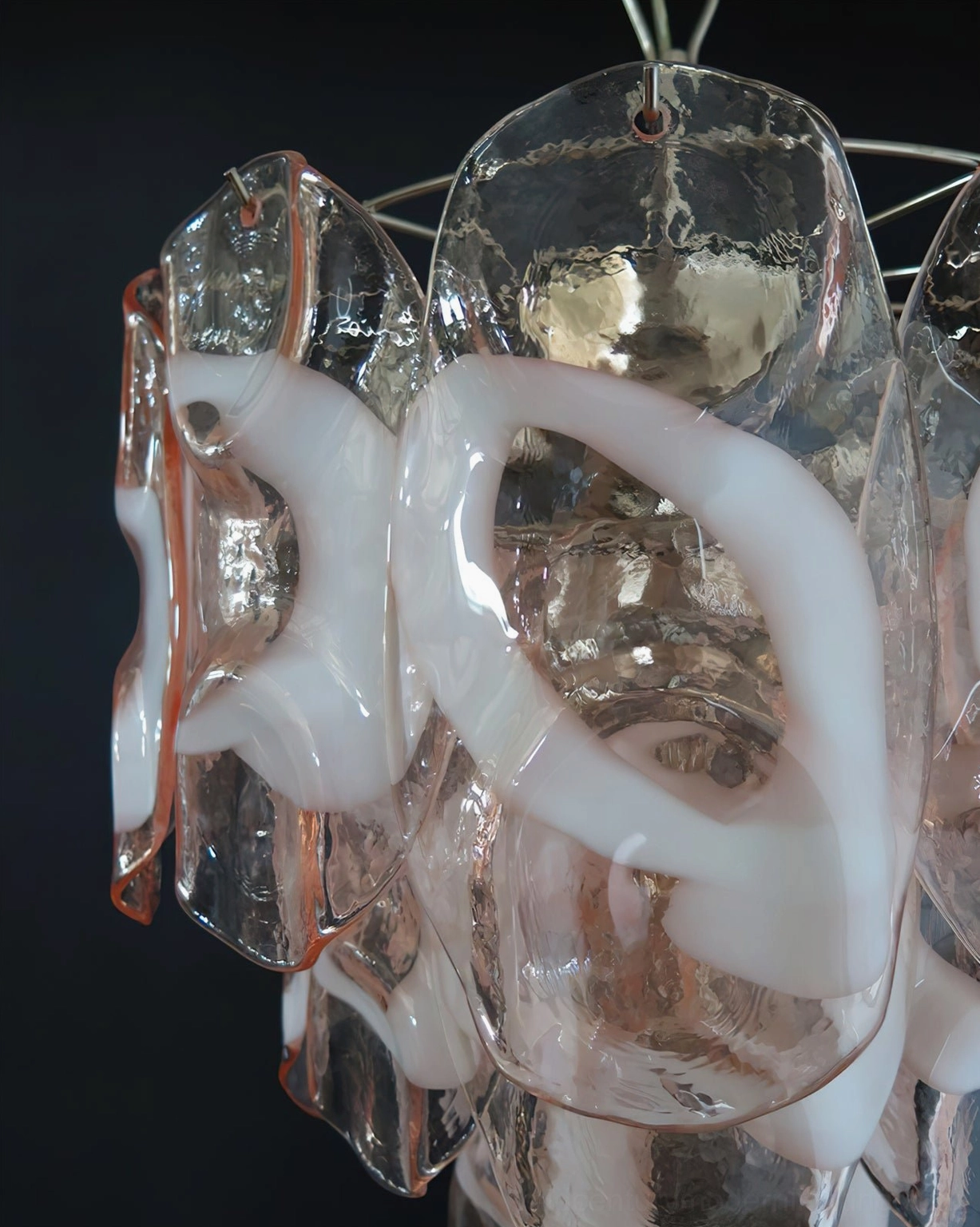 Macro close-up detail of Delara glass components showing thick transparent pink glass with white opaque inlays and artistic swirl pattern