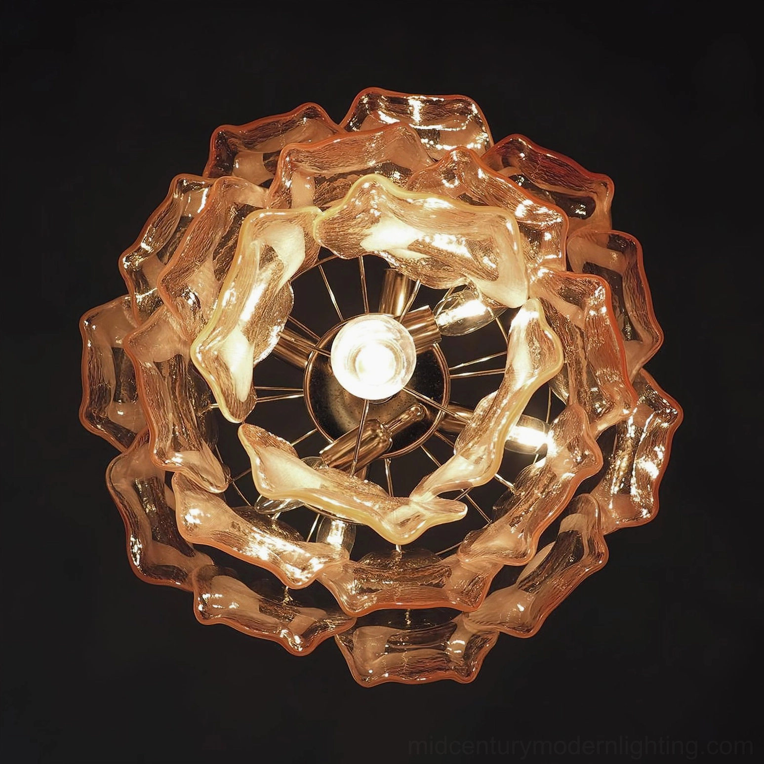 Bottom-up view of illuminated Delara pink glass chandelier against black background, showing exposed metal frame and warm LED glow through glass