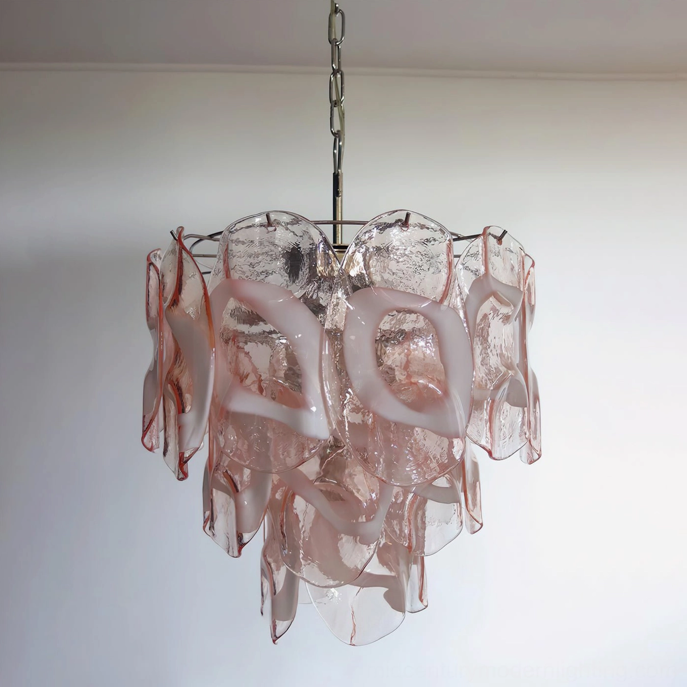 Close-up of Delara pink glass chandelier with metal hanging chain, displaying handcrafted glass texture and layered petal structure