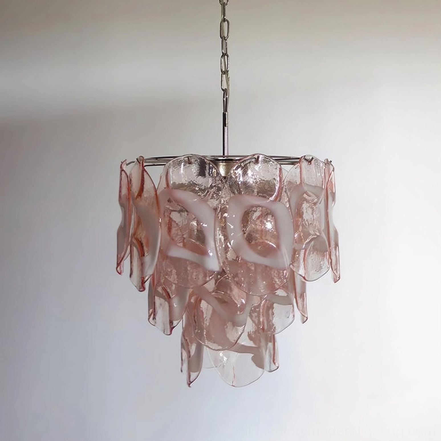 Delara pink and white Murano glass chandelier hanging against neutral gray wall, highlighting the delicate glass color gradation