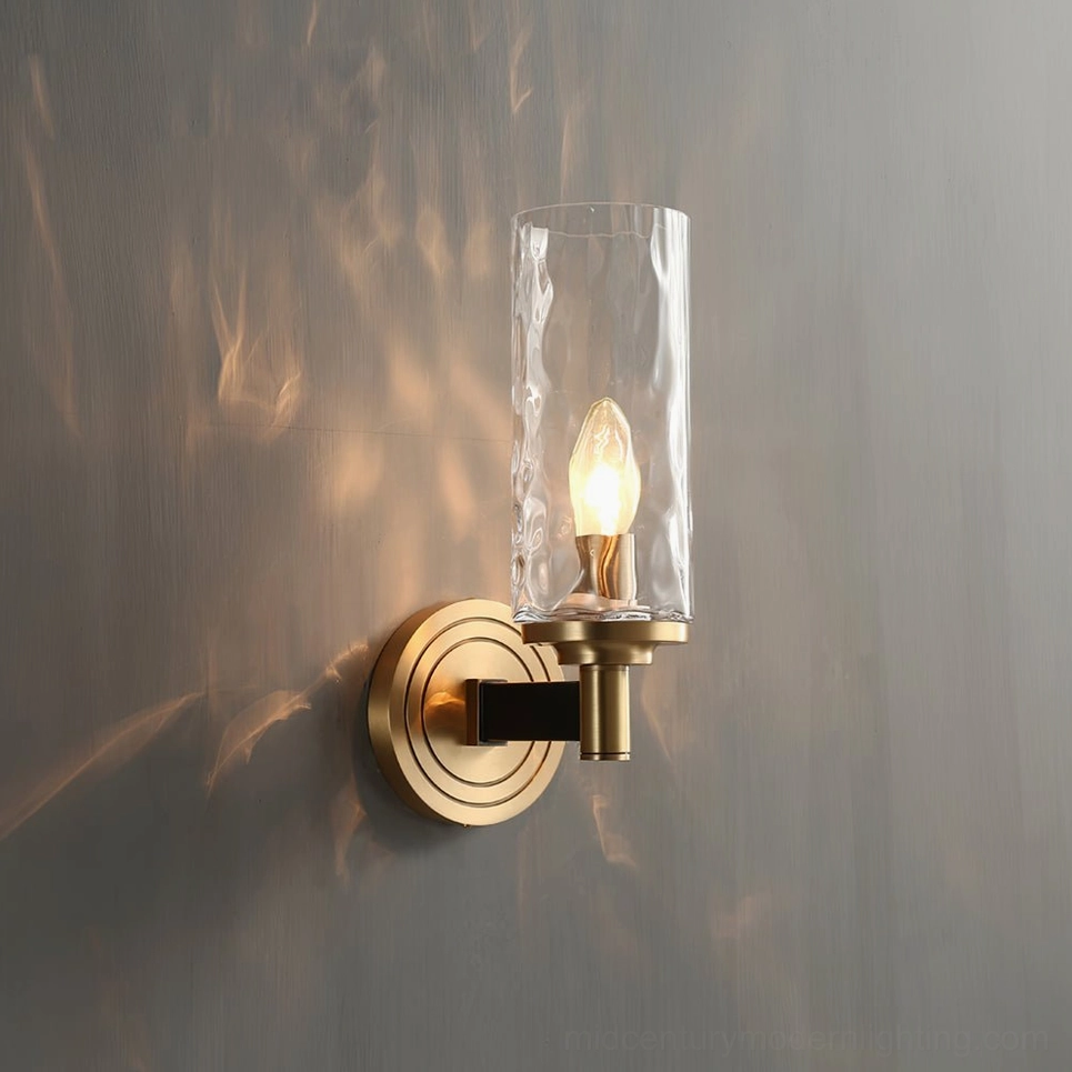 Devora compact wall lamp close-up showing warm brass finish and candle-style bulb detail