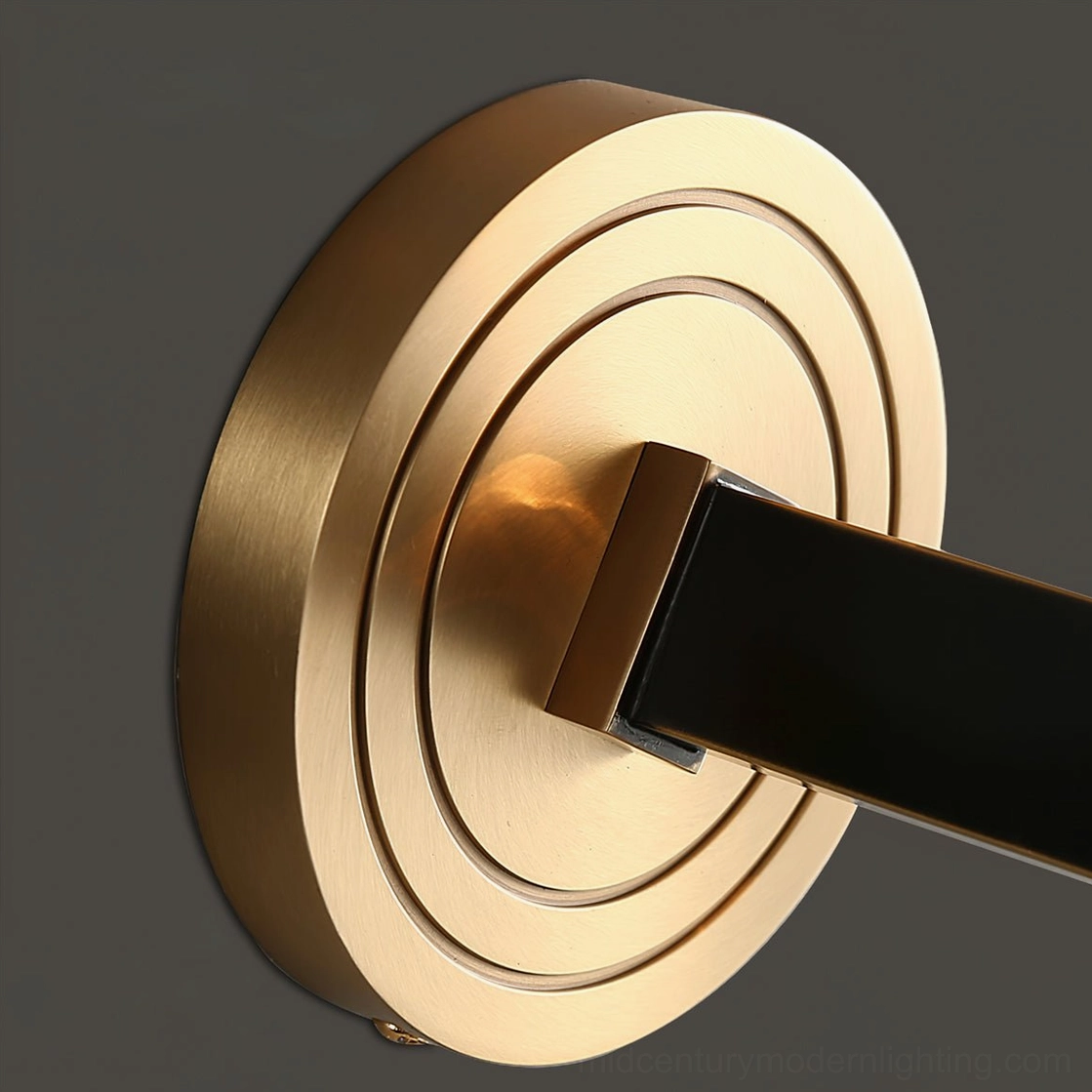 Devora brass wall light installed in contemporary home interior with warm glow