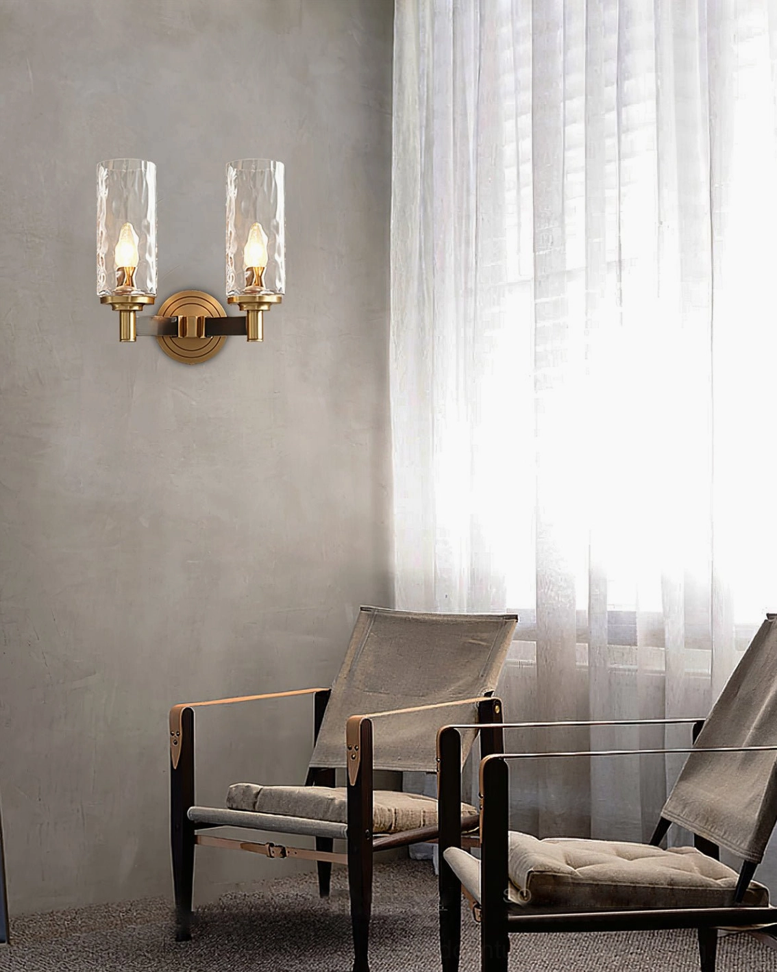 Pair of Devora dual brass wall sconces in minimalist sunlit living room with neutral decor