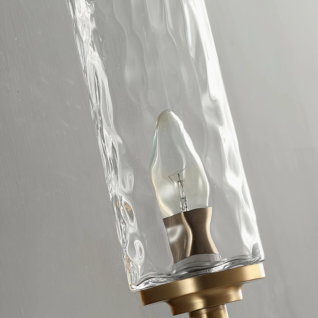 Devora wall sconce close-up of brass mounting hardware and rippled glass shade
