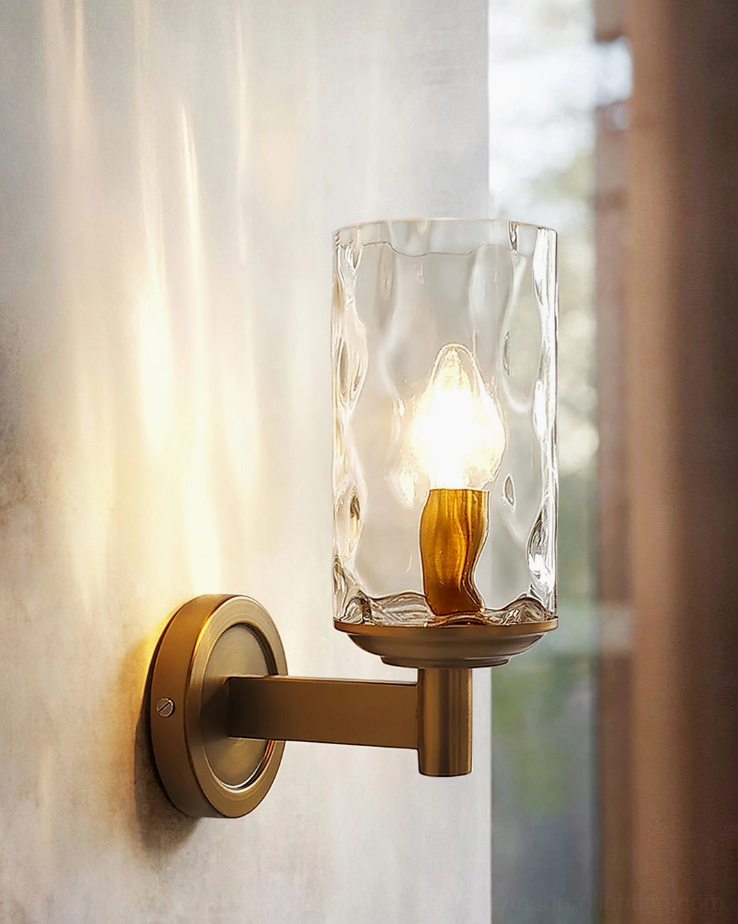 Devora wall sconce detail shot showing clear rippled glass shade and exposed brass hardware