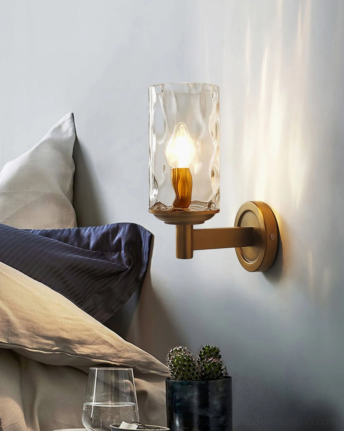 Devora wall lamp side profile view, dark bronze finish with textured glass shade