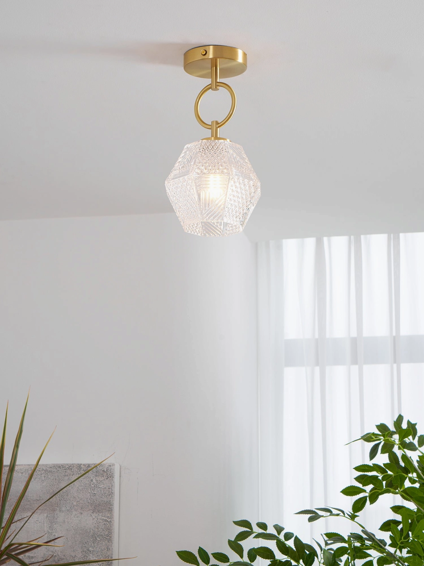 Faceted glass shade of diamond cut Art Deco light with antique brass hardware
