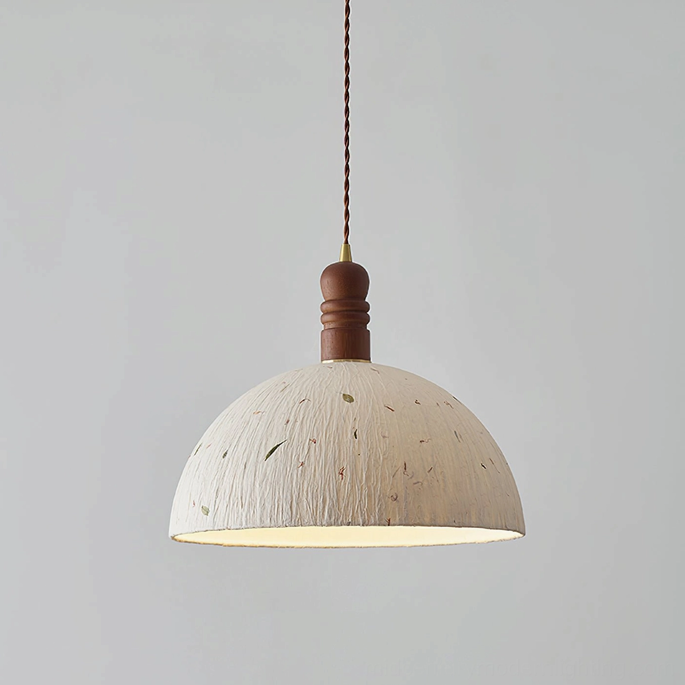 Diana handcrafted pendant light showcasing organic paper texture and natural leaf specimens in warm light